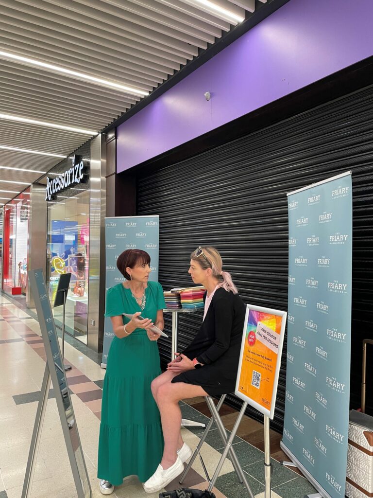 Colourist giving advice to woman on the colours that suit her complexion